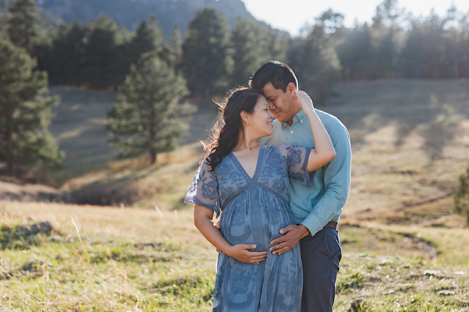 Boulder Colorado maternity photographer chautauqua park golden hour mountain session Gather and Abide Photography blue dress flowers baby's breathe asian american mom and dad firstborn